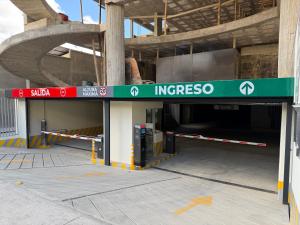 a parking garage with a sign that reads ingresoser at Cozy Room Calacoto in La Paz