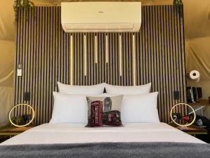 a bedroom with a bed with white pillows at Go Glamping NZ Ltd in Alexandra