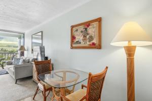 a living room with a glass table and chairs at Lahaina Shores #532 in Lahaina