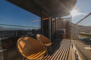 two chairs on the balcony of a house at Starlight Escape - Ohana in Lake Tekapo