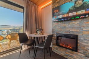 a living room with a fireplace and a tv at Starlight Escape - Ohana in Lake Tekapo