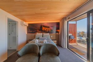 a bedroom with a large bed and a large window at Starlight Escape - Ohana in Lake Tekapo +21 photos