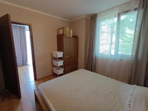 a bedroom with a bed and a window at Sirena condo 50 m from the central beach in Byala +35 photos