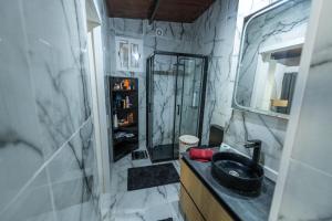 a bathroom with a shower and a black sink at Oasis fataga 2 in San Bartolomé