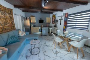 a living room with a blue couch and a table at Oasis fataga 2 in San Bartolomé