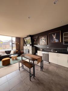 a living room with a table and a couch at Cardrona Alpine Luxe in Cardrona