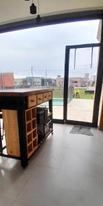 a room with a desk and a sliding glass door at Glamping privado con pileta y quincho in San Vicente