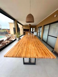 a large wooden table in the middle of a room at Glamping privado con pileta y quincho in San Vicente