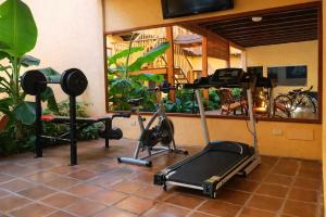 a gym with two exercise bikes and a treadmill at Hotel El Maltese - Lakefront in Granada