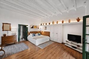 a bedroom with a bed and a flat screen tv at La Hacienda Grande in Puerto de la Cruz