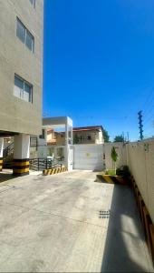 a large building with a fence and a driveway at Studio V Ininga in Teresina