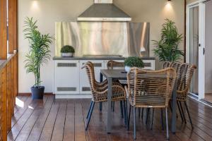 a dining room with a table and chairs at Amaroo Cottage Smiths Lake in Smiths Lake