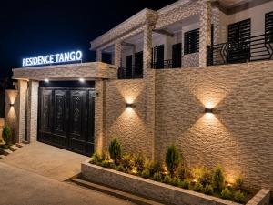 a brick building with a sign that reads translate tango at Résidence Tango - Appartements Meublés - 4 types in Bafoussam