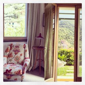 a living room with a chair and a window at La Casa di Andrea Relais in Monterosso al Mare