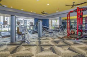 a gym with treadmills and equipment in a building at Humble cozy home in Humble