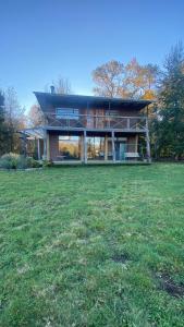 a large house with a lawn in front of it at Cabañas Flor de Conquil in Villarrica