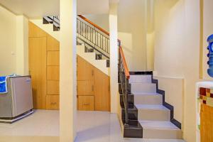 a staircase in a house with a refrigerator at Hotel O Sofia Homestay Syariah in Bogor