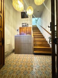 a hallway with a staircase with lights and a stair case at Casa Real Circacia in Circasia
