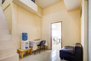 a living room with a table and a chair at Hotel O Sofia Homestay Syariah in Bogor
