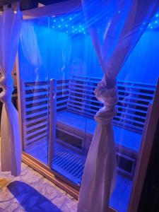 a room with a window with blue lights at Villa Forko Luxury Spa Near Paradise Beach in Lopar