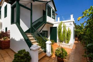 a white house with a staircase and cactus at La Hacienda Grande in Puerto de la Cruz +26 photos