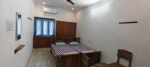 a room with a bed in the corner of a room at Santha Residency in Ambātturai +11 photos