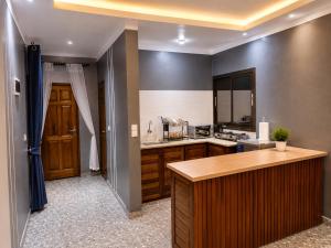 a large kitchen with a counter top and a counter top at Résidence Tango - Appartements Meublés - 4 types in Bafoussam