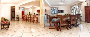 a dining room and kitchen with a table and chairs at Kasa First Apartment in Mtwapa