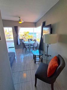 a living room with a couch and a table at Turquesa by the Sea, Elevated Ocean View Retreat in San Carlos