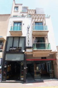 a store front of a building on a street at Gold Palace Hotel in San Juan de los Lagos