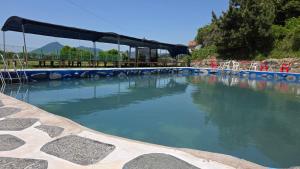 a large pool of water with tables and chairs at Namhae Camp Village in Namhae