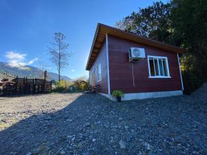 a small house with a window on the side of it at Departamentos Eldestino in Puerto Puyuhuapi