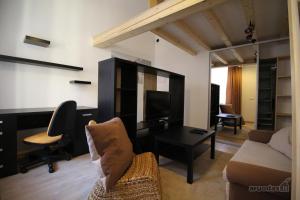 a living room with a couch a table and a tv at Giedres Old town studio in Kaunas