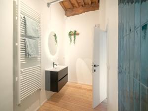 a bathroom with a sink and a mirror at Stylish Duplex for 6 in Antwerp in Antwerp +12 photos