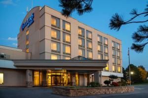 a building with a sign on the front of it at Allure Hotel & Conference Center in Barrie