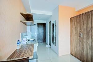 a kitchen with a stove and a counter top at Hotel O Tridasa in Medan