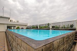 a swimming pool on top of a building at Hotel O Tridasa in Medan +20 photos