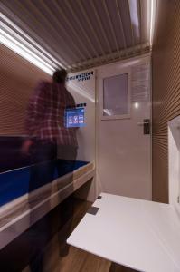 A television and/or entertainment centre at Resting Pods - -ZZZleepandGo MXP Airport