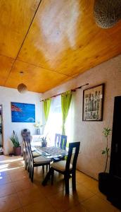 a dining table and chairs in a living room at Hare Te Maori in Hanga Roa