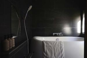 a bathroom with a bath tub with a shower at The Cabin by Deep Gorge in Kita-karuizawa +10 photos