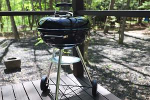 a grill sitting on a stand on a table at The Cabin by Deep Gorge in Kita-karuizawa