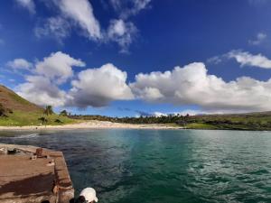 a view of a beach and the ocean on a sunny day at Hare Te Maori in Hanga Roa