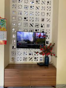a flat screen tv on top of a entertainment center at Nhật Lệ Oyster House in Dong Hoi