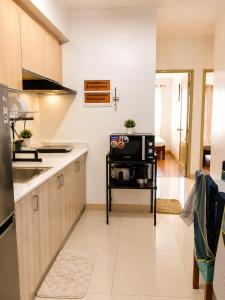 a kitchen with a sink and a microwave at Davao City Stay at Camella Northpoint Spacious 3BR Condo 5Beds Up to 10 Guests in Davao City
