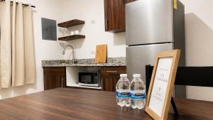 two bottles of water sitting on a table in a kitchen at Lumina loft express minutes to consulate in Hermosillo