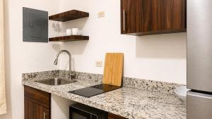 a kitchen with a sink and a counter top at Lumina loft express minutes to consulate in Hermosillo