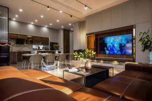 a living room with a couch and a tv at La Lapine Villa -6rooms-15Pax in Khu Chi Lăng