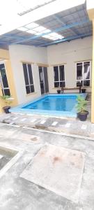 a swimming pool in the middle of a building at Ayem Resort Langkawi in Air Hangat