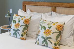 a group of pillows sitting on a bed at Villa Anosia Laman i Tera in Westpunt