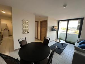 a dining room table and chairs in a living room at Angies Loft in Tegucigalpa